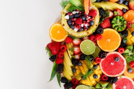 Colorful flat lay of assorted tropical fruits including pineapple, berries, and citrus.