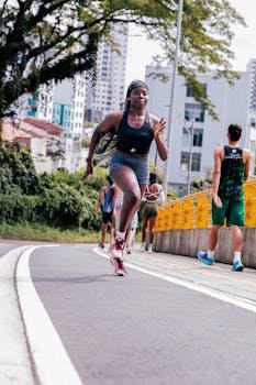 Focused athlete sprinting outdoors on a city track, inspiring fitness and endurance.
