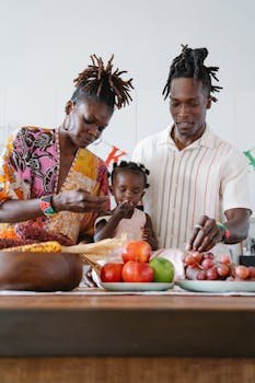 A family bonds over fruits in an indoor kitchen, creating joyful moments together.
