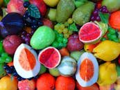 A diverse and vibrant array of colorful fruits, featuring various shapes and textures.